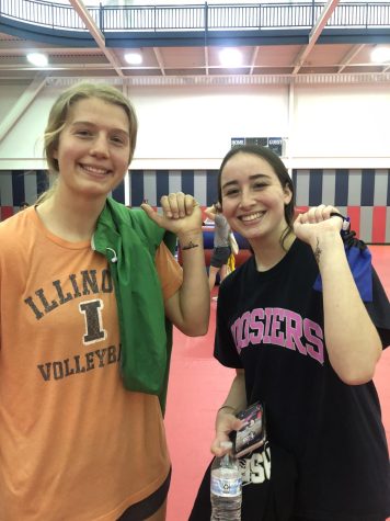 Natalie Niehaus, freshman exercise science major, and Emma Harris, freshman marketing major, show off the temporary tattoos they got at Condom Carnival Wednesday in the Recreation, Fitness and Wellness Center. (Photo by Alyssa DeWig)