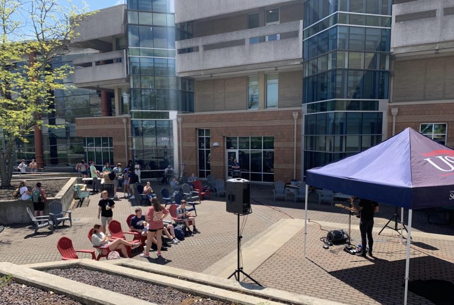 Students gather outside the Performing Arts Center to watch Matt Jackson perform live music for SpringFest Friday. (Photo by Anthony Rawley)