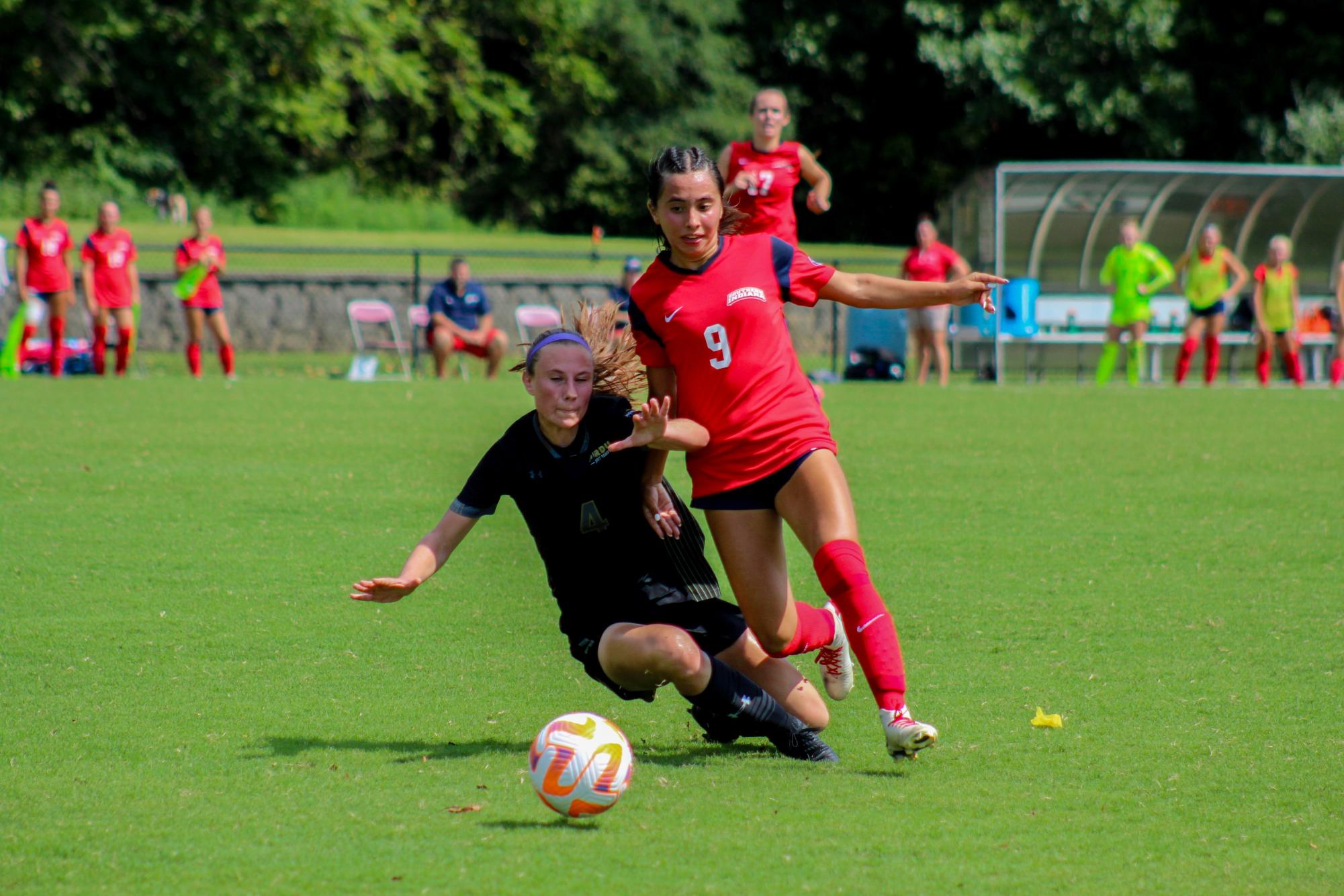 Pilar Torres, freshman midfielder, collides with a Purdue University Fort Wayne player Sunday at Strassweg Field. 