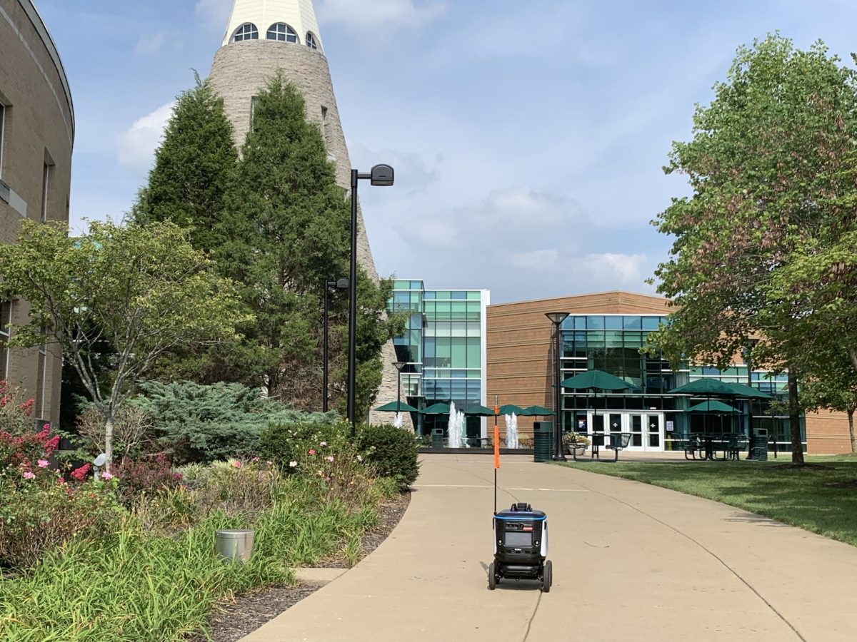 A Kiwibot delivery robot drives past the University Center Fountain Aug. 23.
