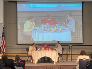 Audrey Fox, APB President, President Ronald Rochon and Laura Gobert, APB graphic designer, eat wings while Rochon answers questions Tuesday in Carter Hall located inside University Center West.