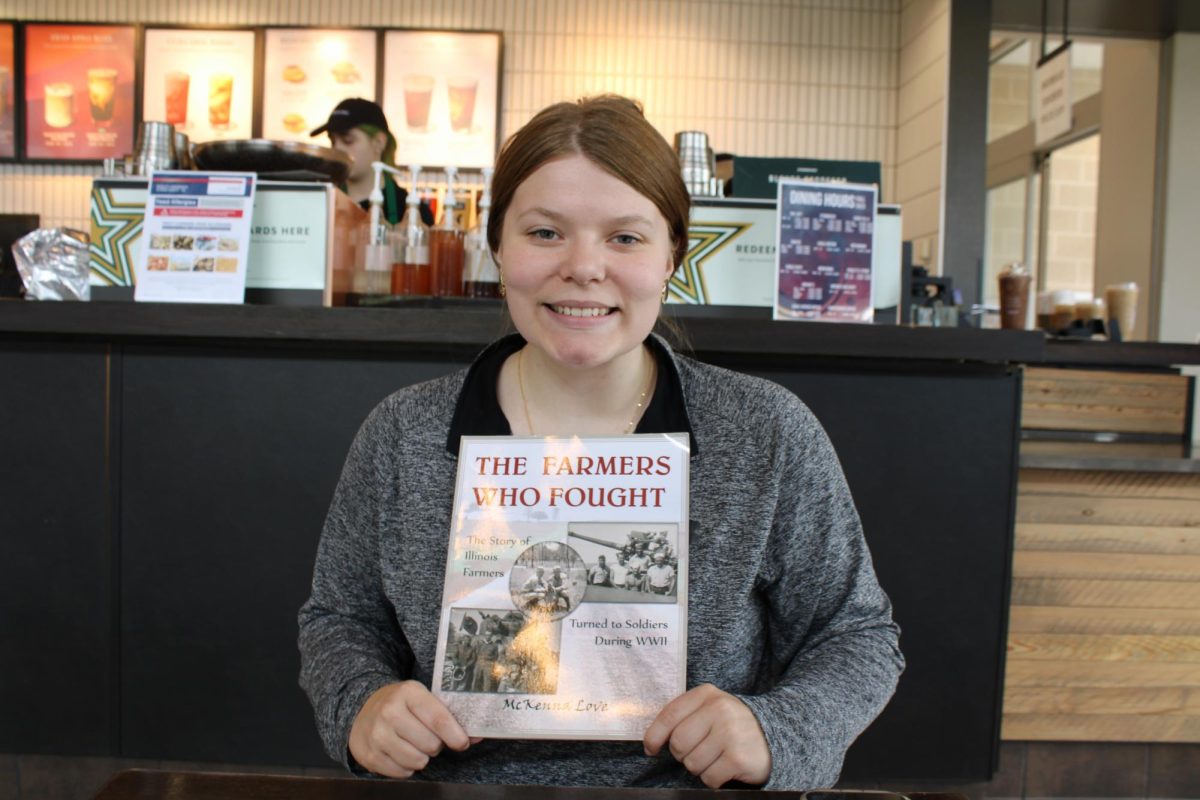 McKenna Love, sophomore history major, poses with her published book, The Farmers Who Fought, Sept. 9 at Starbucks in the David L. Rice Library.