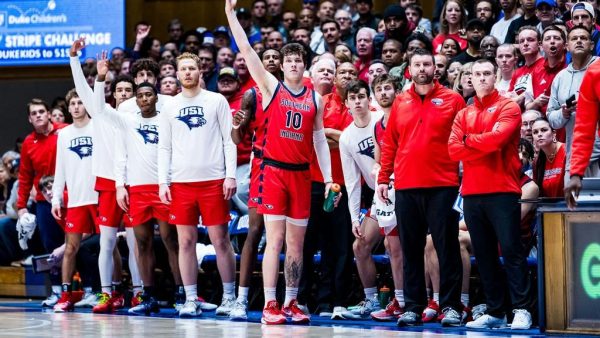 Members of the mens basketball team watch the game against Duke University from the bench Nov. 24 at Cameron Indoor Stadium in Durham, NC. (Photo courtesy of Nat LeDonne and USI Athletics)