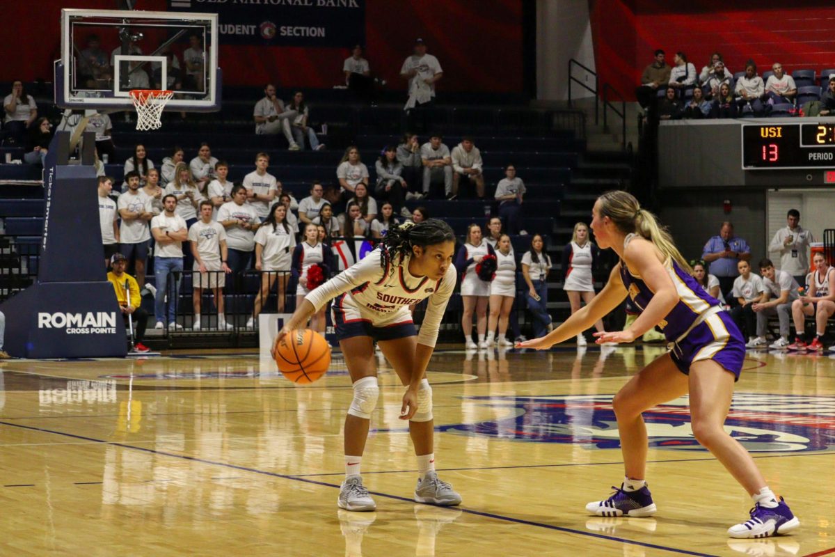 Triniti Ralston, freshman guard, dribbles the ball in front of a Western Illinois University player Thursday in the Screaming Eagles Arena. (Photo by Peyton Peters)