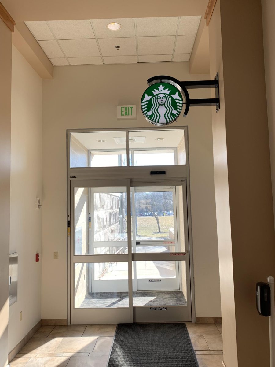A Starbucks sign hangs above the entrance to Starbucks Monday in the David L. Rice Library.
