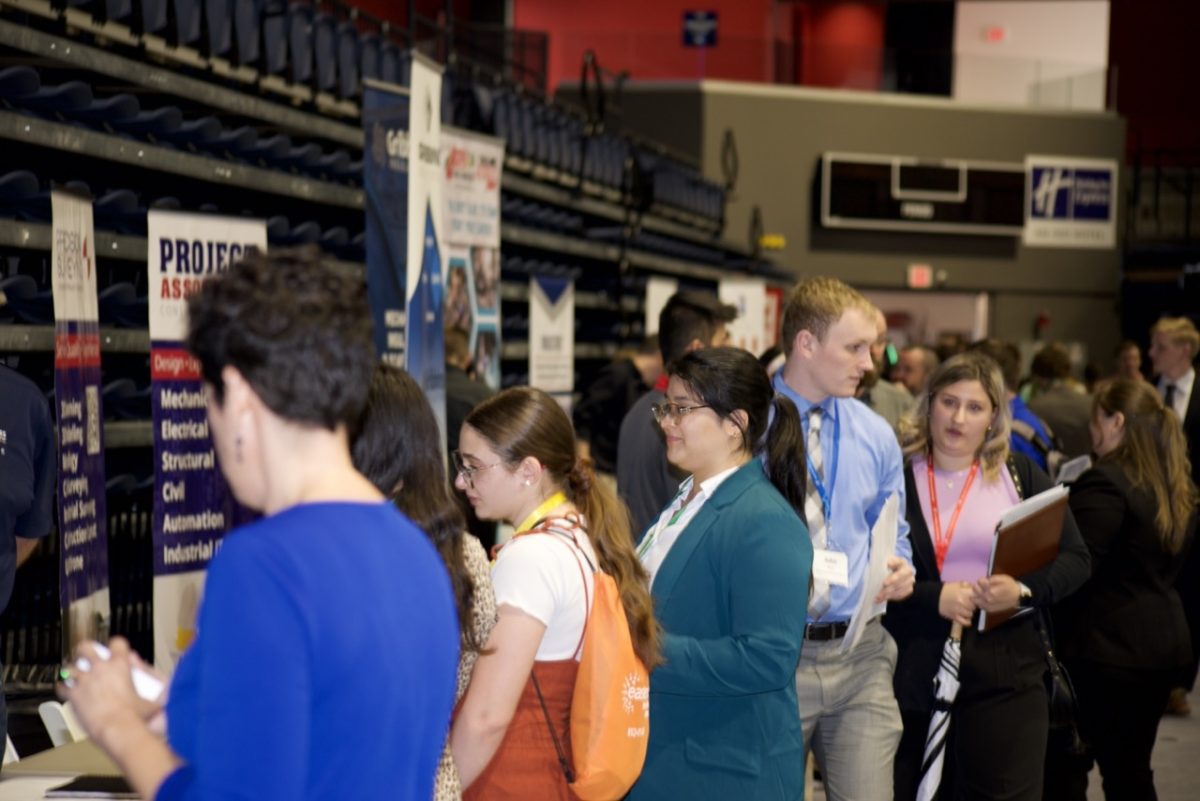 Students and alumni network with potential employers Feb. 20 at the Career and Internship Fair in the Screaming Eagles Arena. (Photo by Ethan MacCowan)