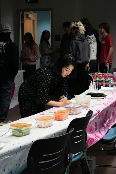 Japanese Club members prepare for the Setsubun Celebration, and attendees gather to talk before the event Friday in the Liberal Arts Center 1004.