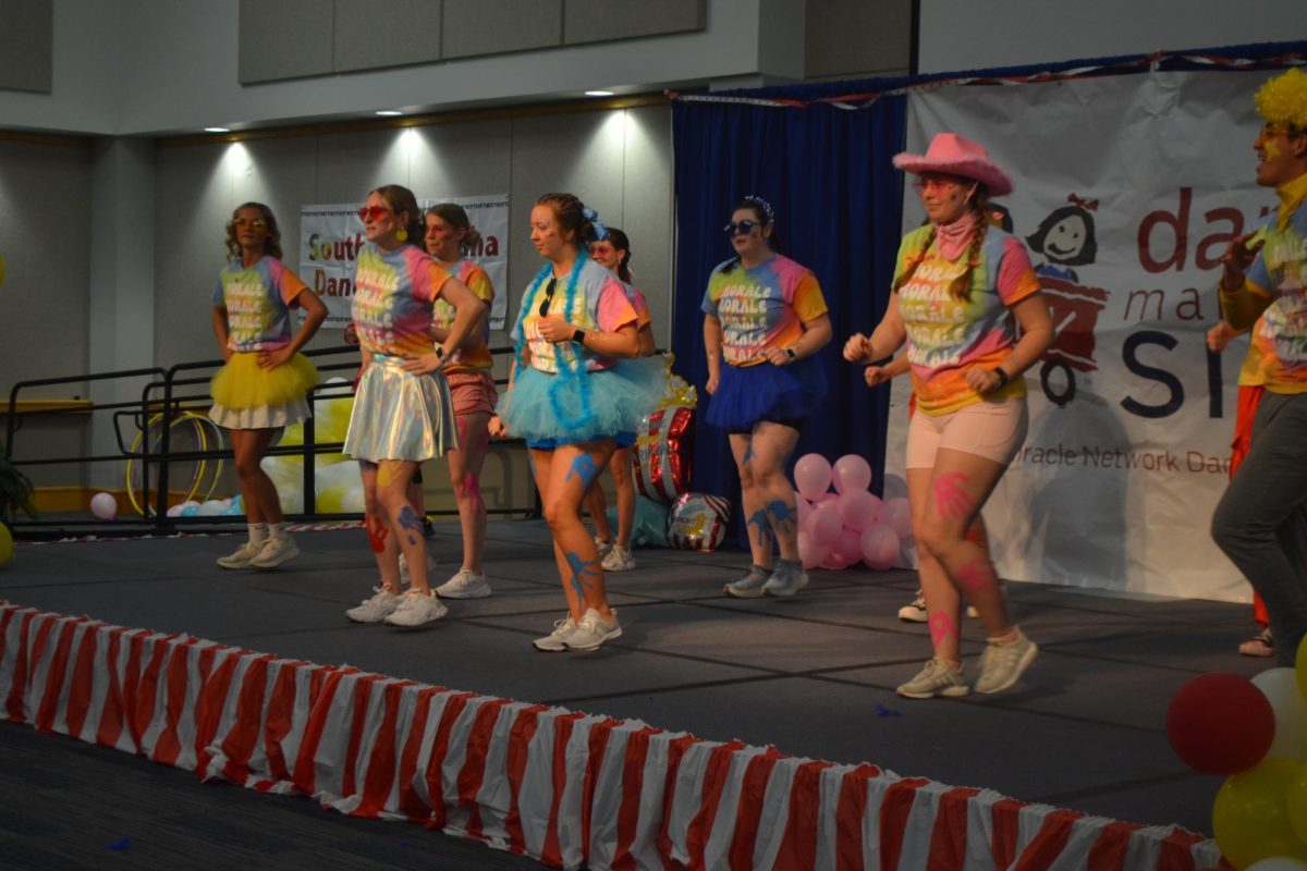 The Morale Squad dances a routine on stage for the Southern Indiana Dance Marathon Saturday in Carter Hall.