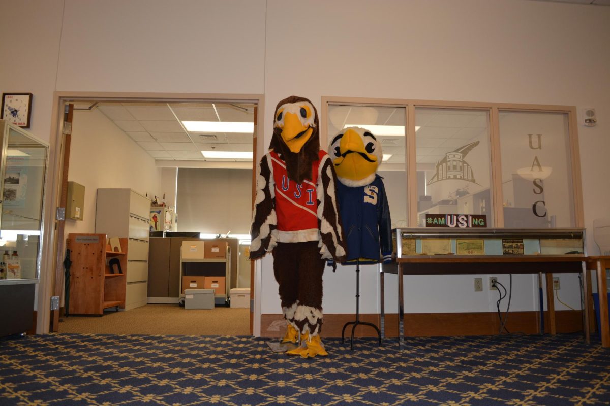 USIs first Archie the Eagle mascot stands on display beside the first ISUE mascot March 12 in the David L. Rice Library.