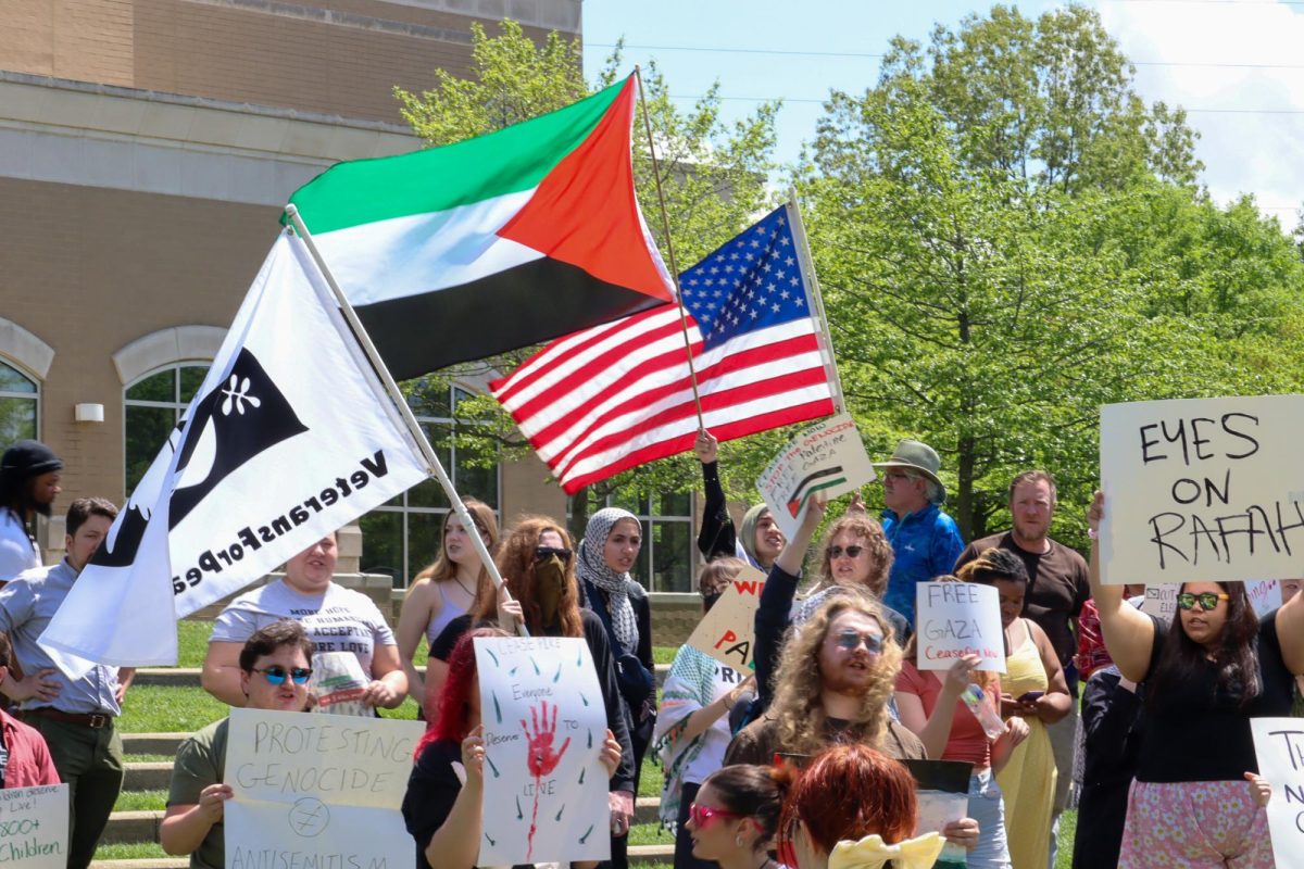 A Veterans For Peace, Palestine and American flag fly at the protest in support of Palestine Tuesday in front of the David L. Rice Library. (Photo by Peyton Peters)