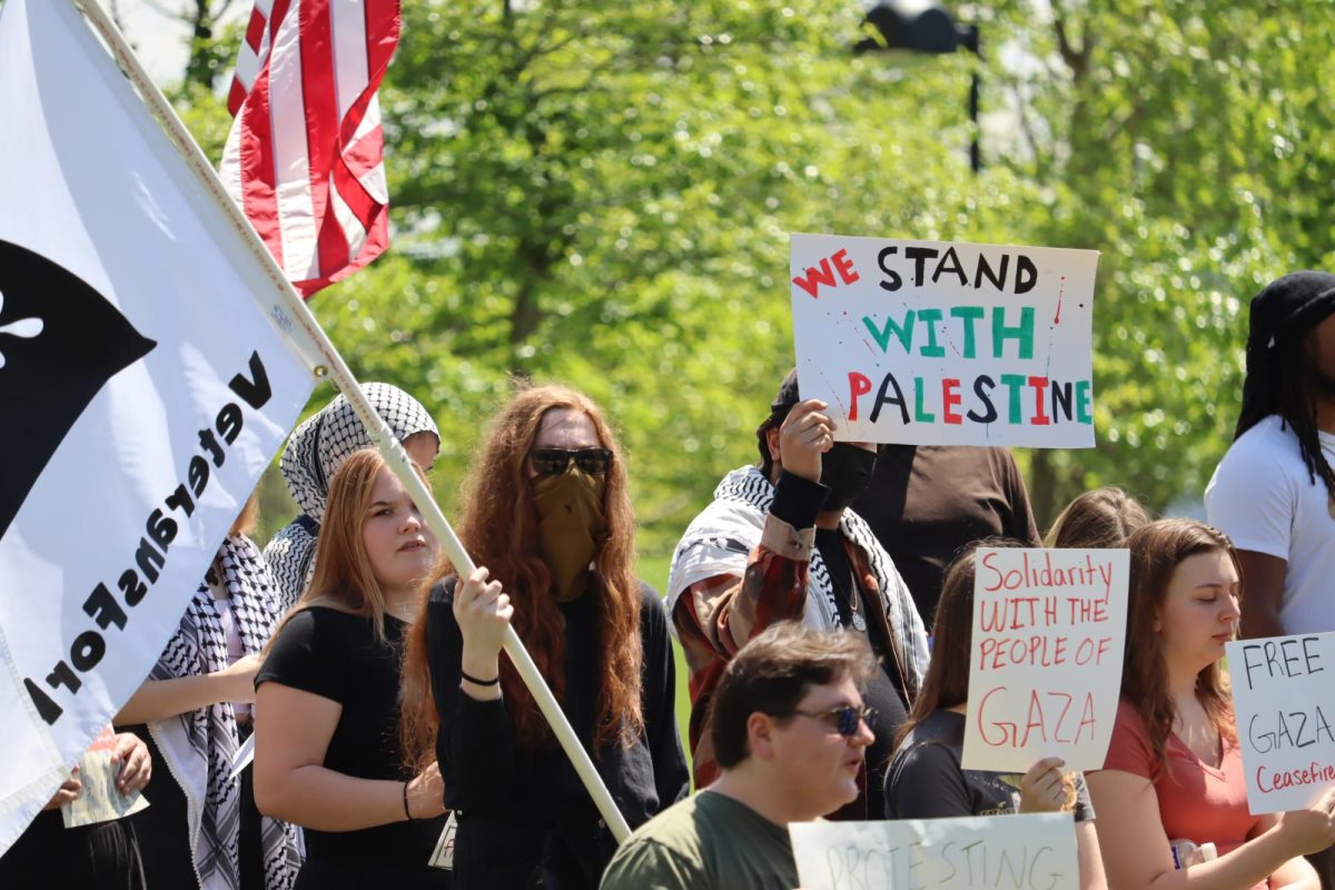 Students hold flags and handmade signs during the protest in support of Palestine Tuesday in front of the David L. Rice Library. 