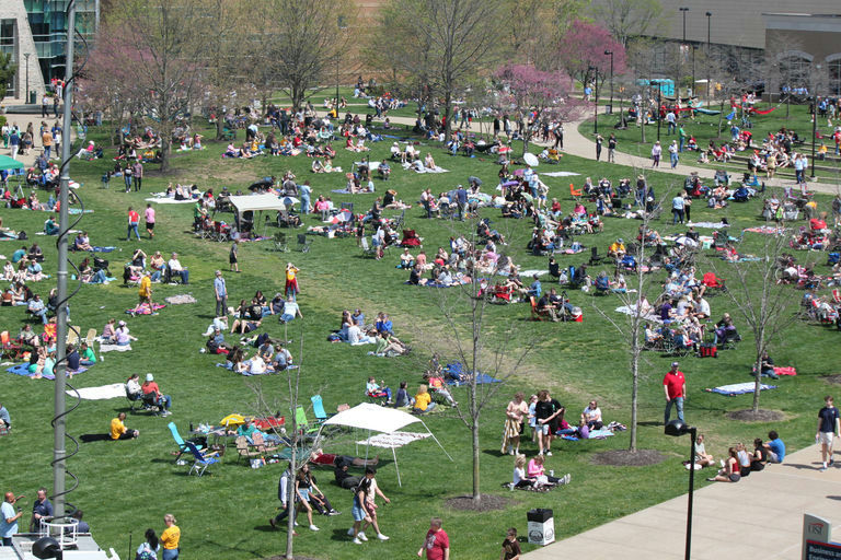 Attendees sit on The Quad to watch the solar eclipse Monday.