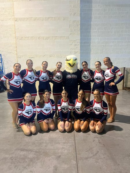 Members of USI dance team smile with Archie the Eagle after competing in the spirit rally performance Thursday afternoon at Daytona, Florida.