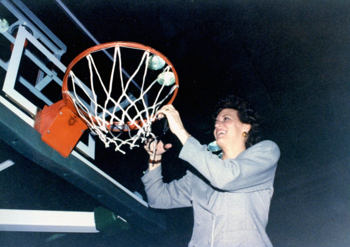Chancellor Dugan, 1997 womens basketball head coach, cuts the net down in the Division II Womens Basketball Tournament. (Photo courtesy of USI Archives, UA 78- University Photographs)