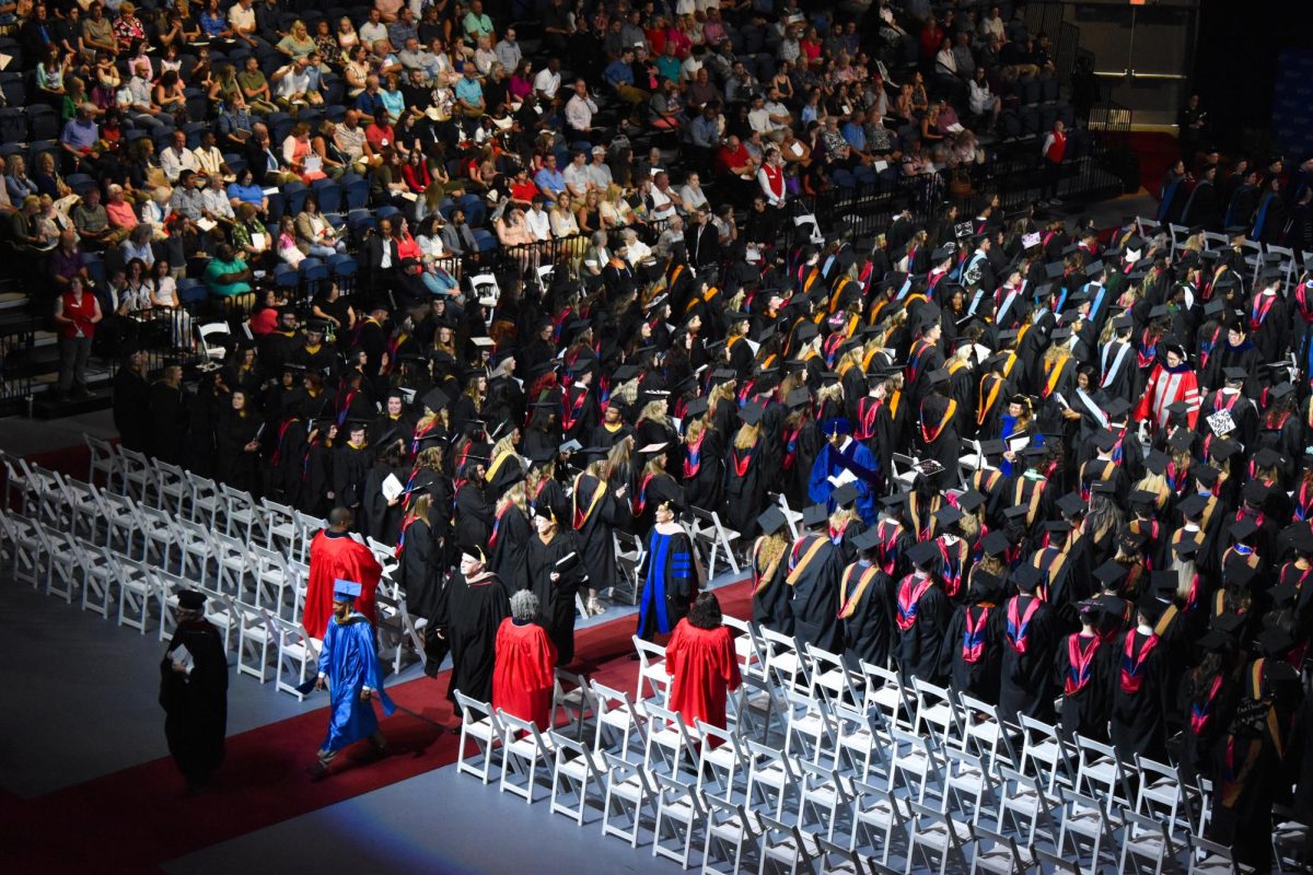 The panel guests exit the arena at the end of the School of Graduate Studies ceremony Friday in the Screaming Eagles Arena.