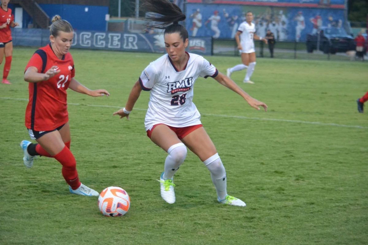 Greta Ohlwein, sophomore forward, rushes a Robert Morris University player Thursday at Strassweg Field. (Photo by Alex Mendoza)
