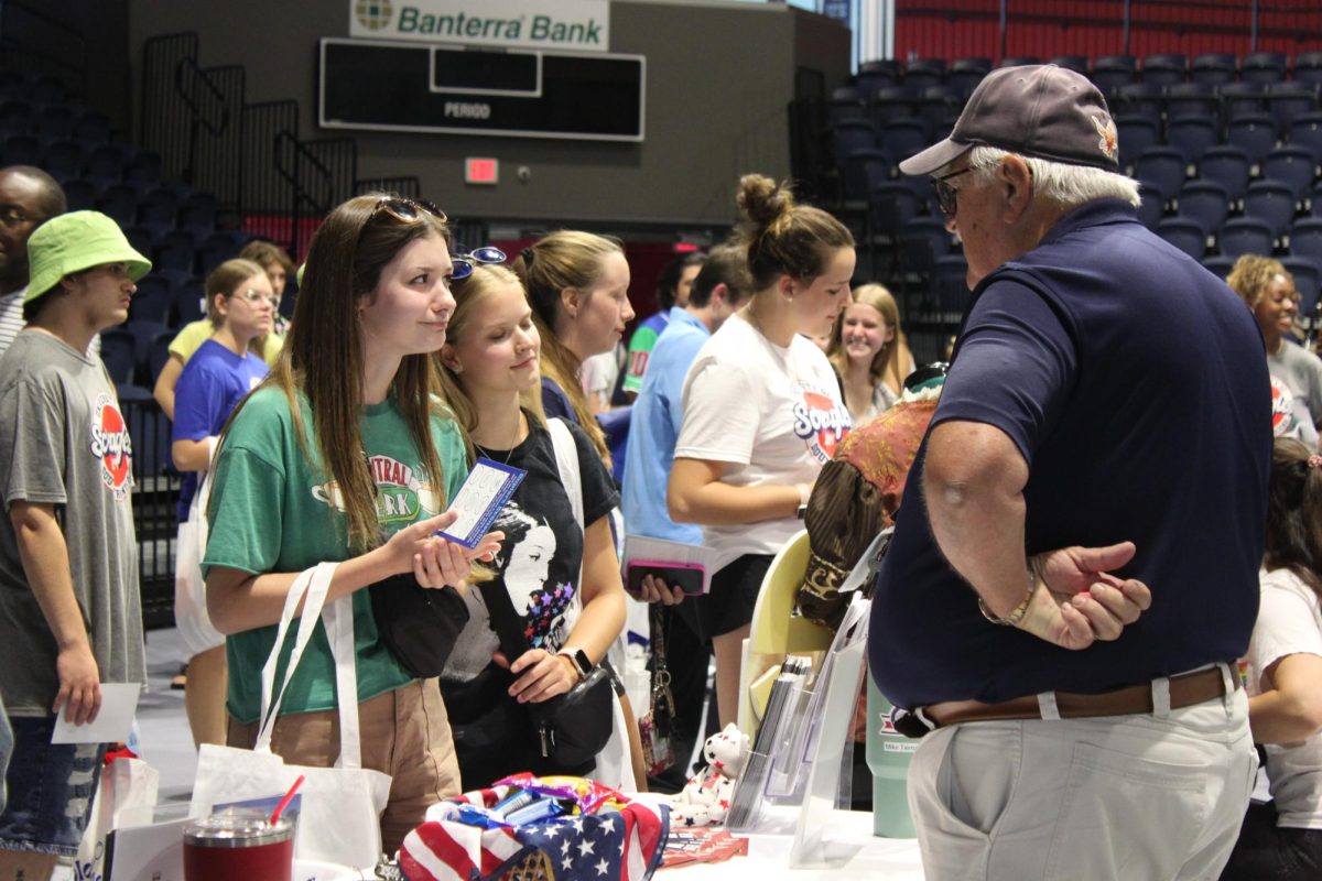 Students visit the Evansville Wartime Museum’s table Friday in the Screaming Eagles Arena.