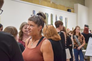 Attendees converse at the Artist Curation Exhibition's opening reception Aug. 24 at the ARTSWIN Gallery.