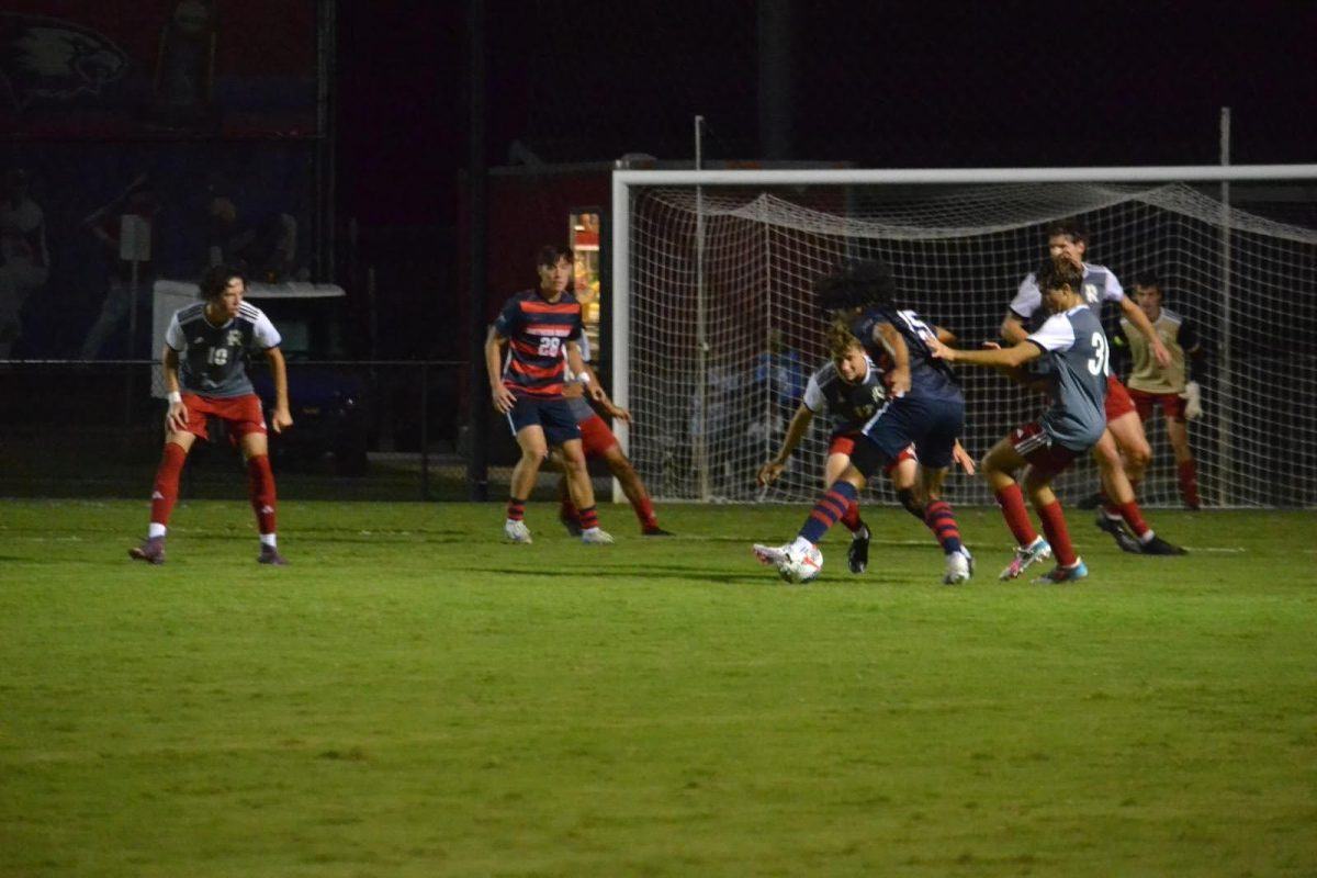 Wesley Rhodes, senior midfielder, is defended by the opponent Wednesday at Strassweg Field. (Photo by Alex Mendoza) 