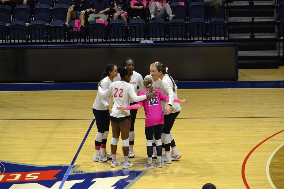 The Screaming Eagles huddle after scoring a point against Western Illinois Friday in the Screaming Eagles Arena. (Photo by Alex Mendoza) 
