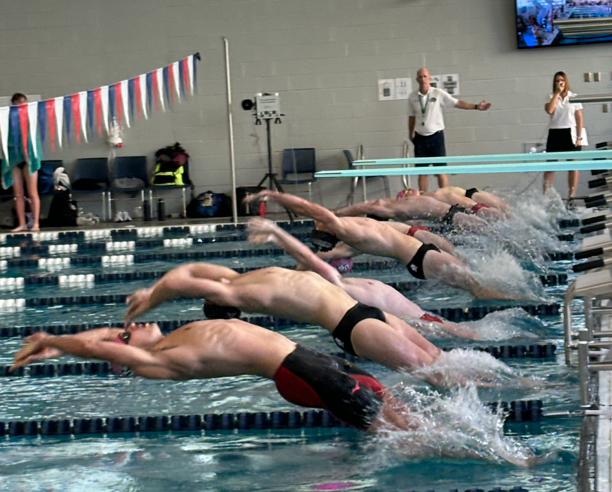 Cole Baker, sophomore sprinter, competes in a 100-meter backstroke competition Saturday in the USI Aquatic Center. (Photo by Will Kessinger)