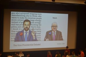 A political cartoon is projected before the vice presidential debate presentation Tuesday in Forum I of the Wright Administration Building.