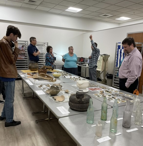 Students and faculty examine artifacts from nearby sites during the open house Monday in the Liberal Arts Center. The new location provides students more space to work in compared to its previous location in the Public Safety building.