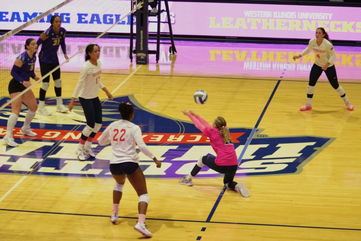 Keira Moore, junior libero/defensive specialist, bumps the ball before it hits the floor Friday in the Screaming Eagles Arena. (Photo by Alex Mendoza) 
