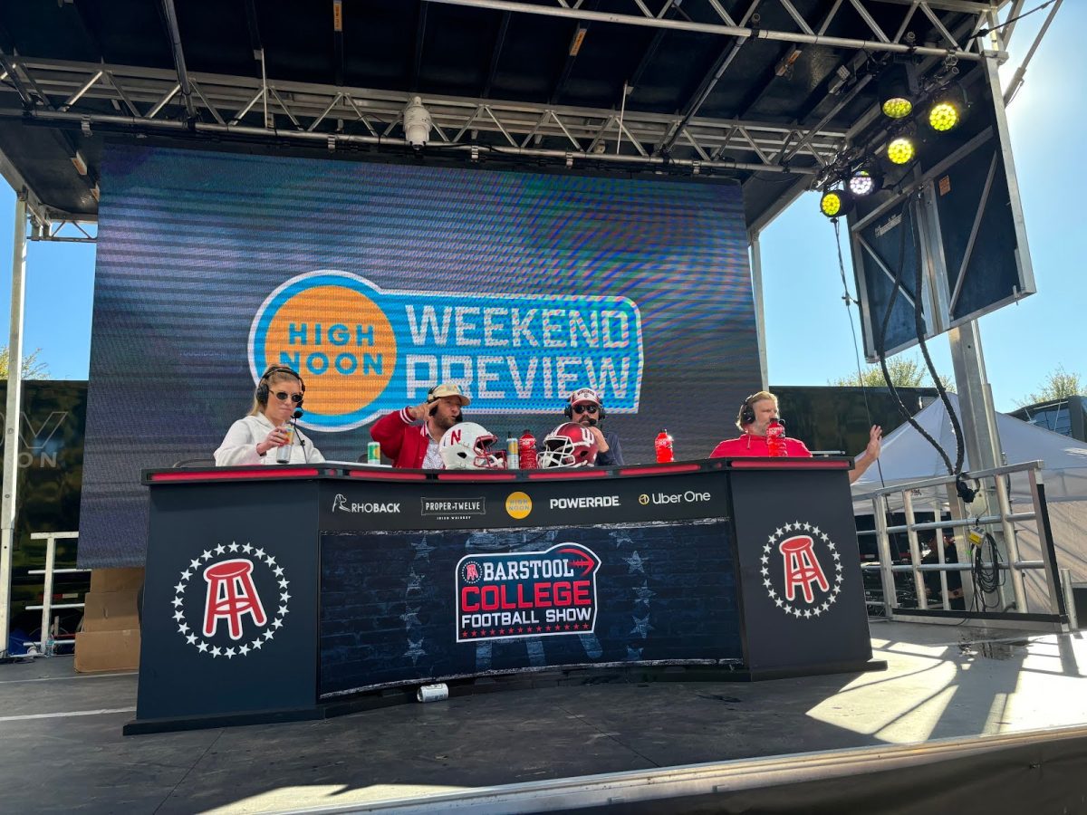 Barstool personalities Kayce Smith, Dave “El Presidente” Portnoy, Dan “Big Cat” Katz and Brandon “BFW” Walker sit at The Barstool College Football Show set Saturday just outside of Memorial Stadium in downtown Bloomington, Indiana. (Photo by Will Kessinger)