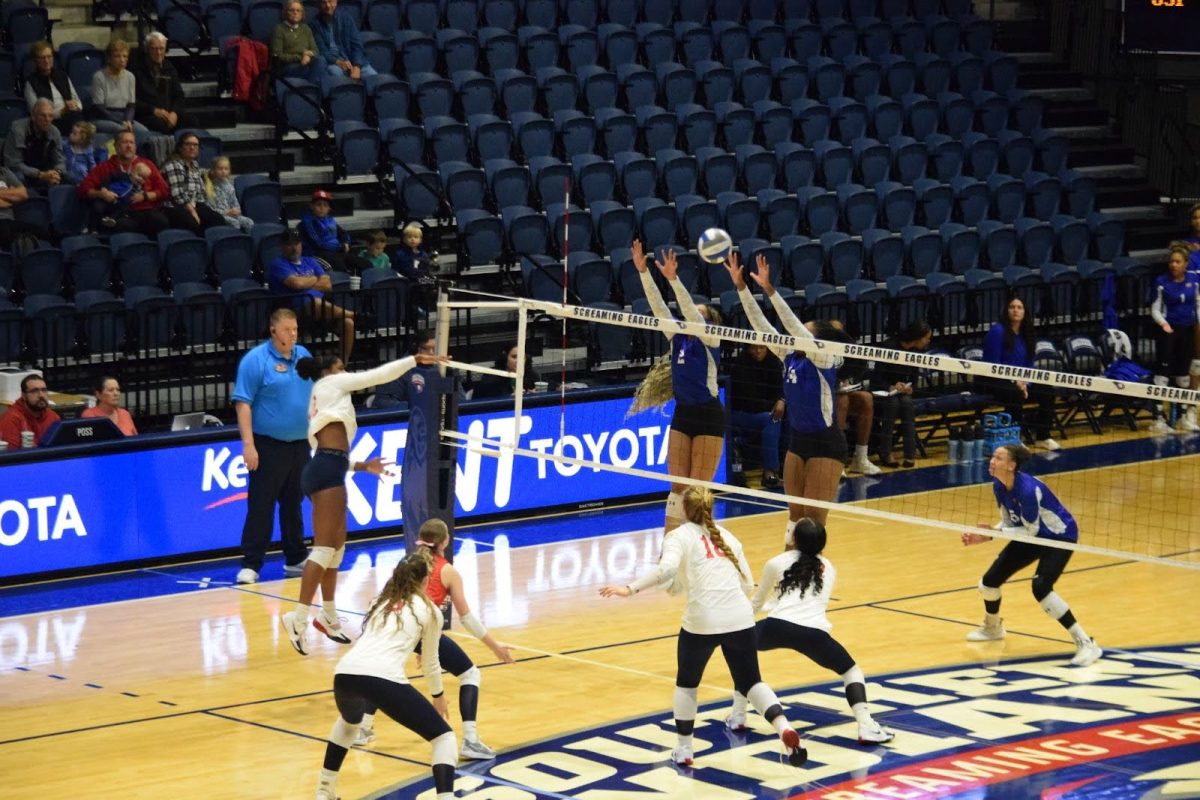 Leah Coleman, sophomore outside hitter, spikes the ball towards Tennessee State University players Friday in Liberty Arena. (Photo by Alex Mendoza)
