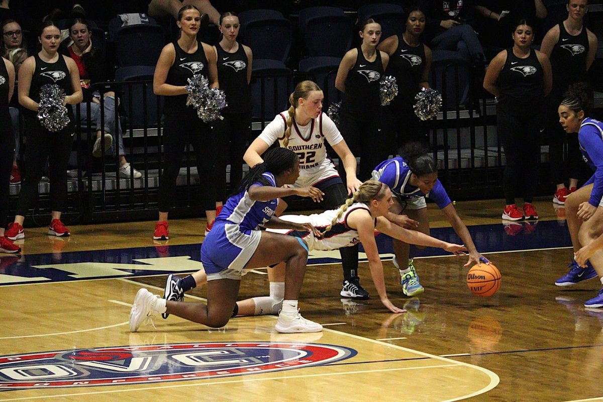 Sophia Loden, sophomore guard/forward, scrambles for a loose ball alongside Saint Louis University players Sunday in Liberty Arena. (Photo by Alex Mendoza)
