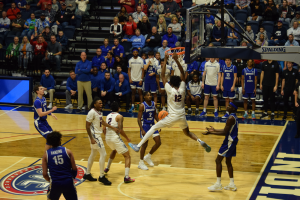 Stephen Olowoniyi, sophomore forward, throws down a two-handed jam Monday in Liberty Arena. (Photo by Alex Mendoza) 
