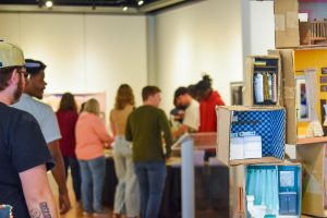 Attendees line up for the food bar at the 55th Annual Juried Student Art Show Sunday in the Kenneth P. McCutchan Art Center. (Photo By Chloé Newman)