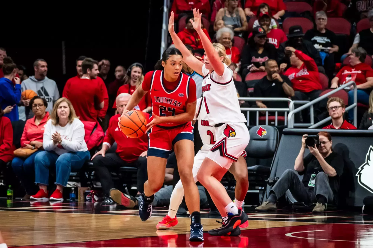 Amiyah Buchannan, sophomore forward, prepares to post up a Louisville player down low in the paint Nov. 8 at the KFC Yum! Center in Louisville, Kentucky. (Photo courtesy of Preston Leinenbach and USI Athletic Communications)
