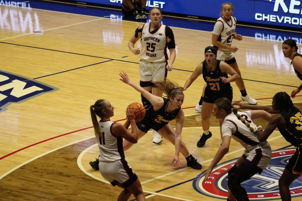 Ali Saunders, senior guard, attempts a mid-range jumper after crossing up a Northern Kentucky University guard Saturday in Liberty Arena. (Photo by Will Kessinger)
