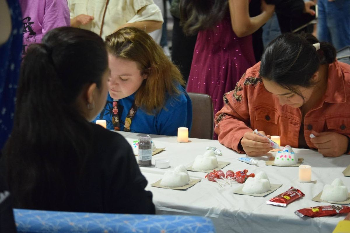 Students decorate sugar skulls Thursday in the Liberal Arts Center.