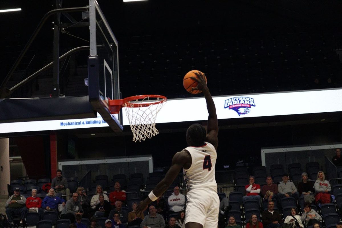 Sam Kodi, junior guard, rises to the rim on a fastbreak dunk late in the game against East-West University Monday in Liberty Arena. (Photo by Will Kessinger)
