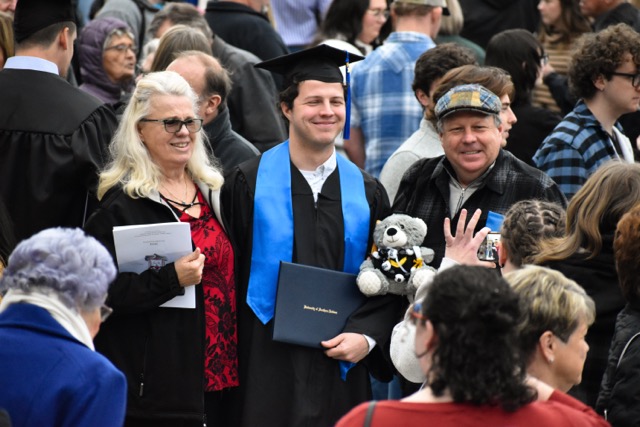 Graduates and their loved ones pose for photos Saturday outside the Liberty Arena.