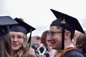 Graduates talk after the College of Liberal Arts, the Romain College of Business and the School of Graduate Studies commencement ceremony Saturday outside the Liberty Arena.