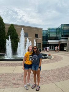 Tegan Ruhl stands with her roommate, McKenna Bacilio, Spring 2024 USI graduate, in front of the USI fountain the day they moved to campus in August 2021. 