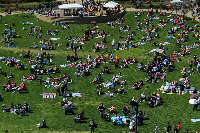 Attendees sit on The Quad to watch the solar eclipse in April.