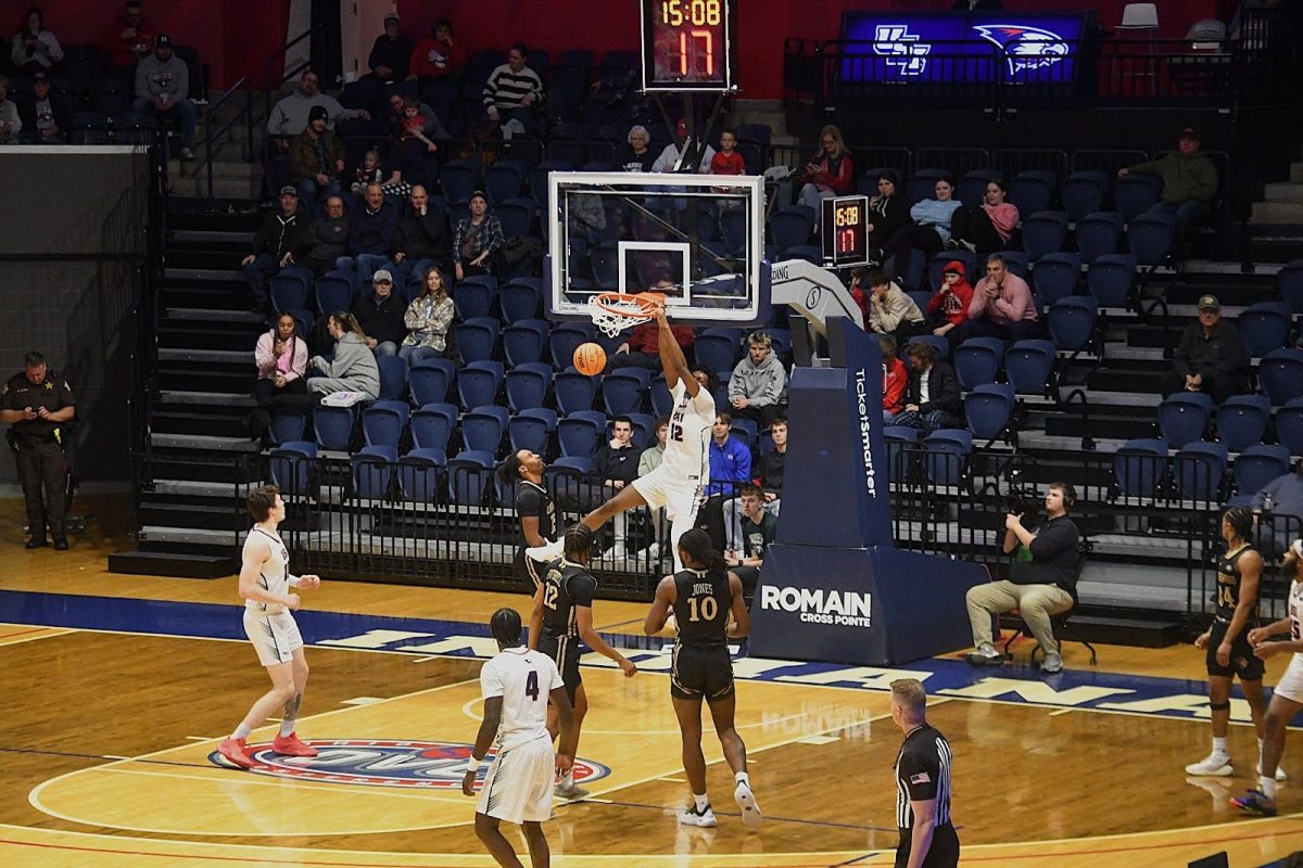 Stephen Olowoniyi, sophomore forward, scores two points via dunk shot against Lindenwood Thursday in the Liberty Arena. (Photo by Alex Mendoza)
