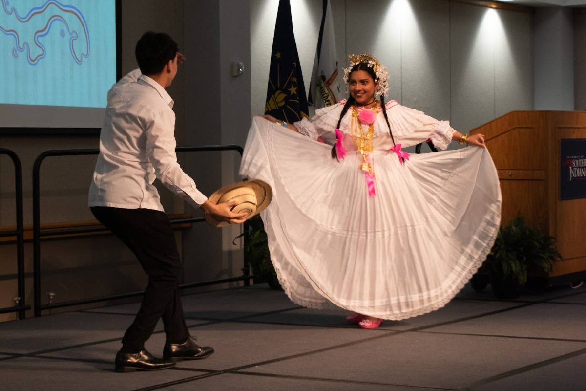 Miguel Garcia, junior kinesiology major, and Nicolle Castillo, sophomore chemistry major, perform a traditional Panamanian dance at the International Food Expo, Friday in Carter Hall.
