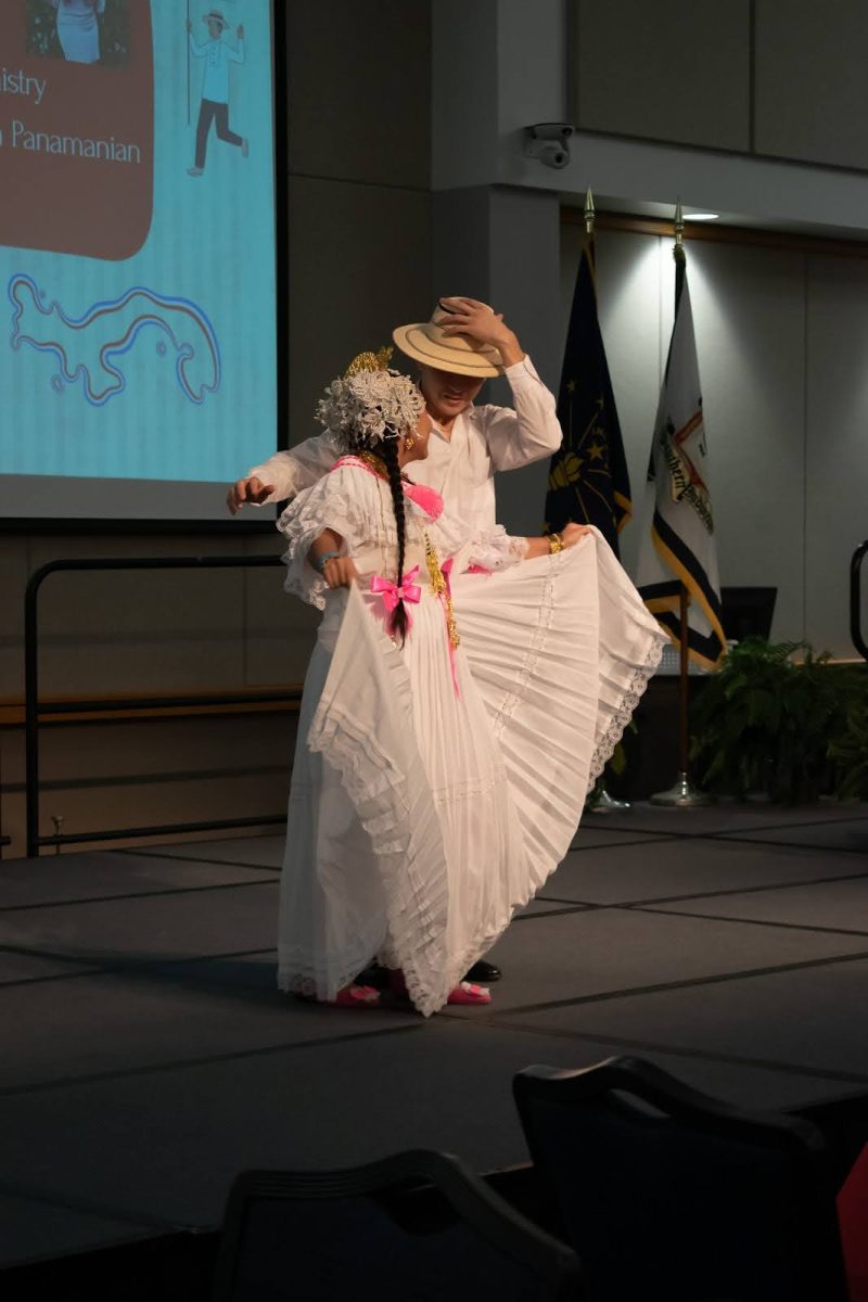 Miguel Garcia, junior kinesiology major, and Nicolle Castillo, sophomore chemistry major, perform a traditional Panamanian dance at the International Food Expo, Friday in Carter Hall.