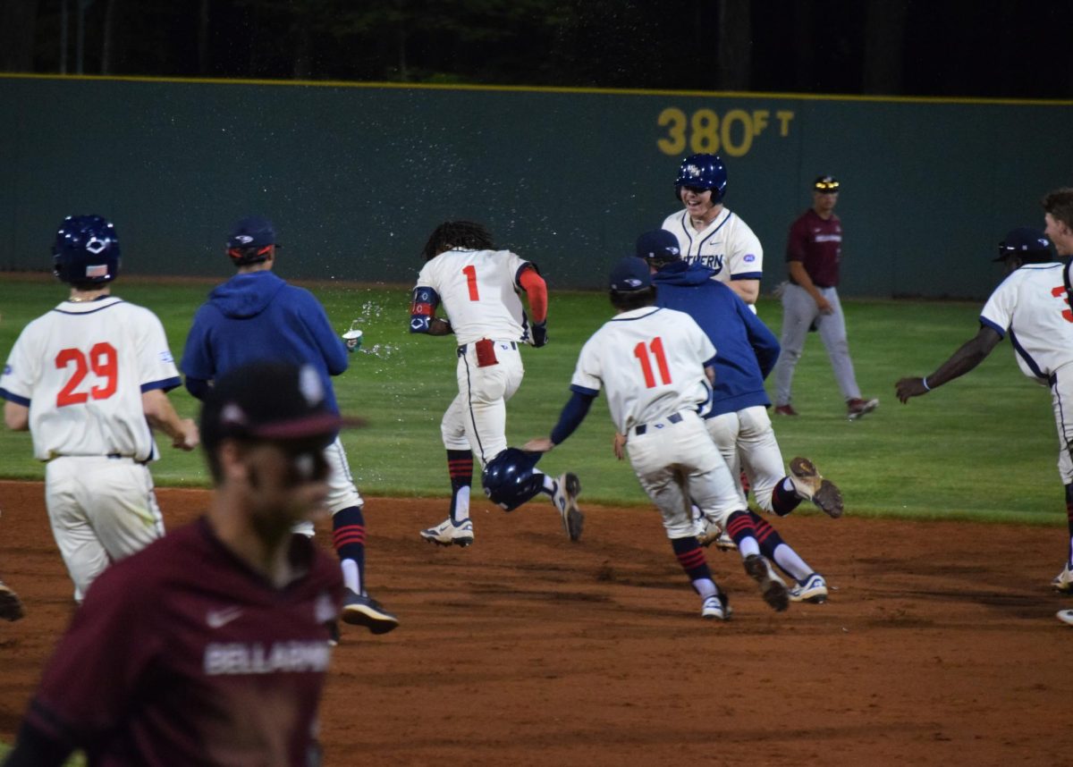 Khi Holiday, senior outfielder, is chased by his teammates after he hit a walk-off single to win the game against Bellarmine in the bottom of the ninth inning Wednesday at USI Baseball Field. (Photo by Will Kessinger)