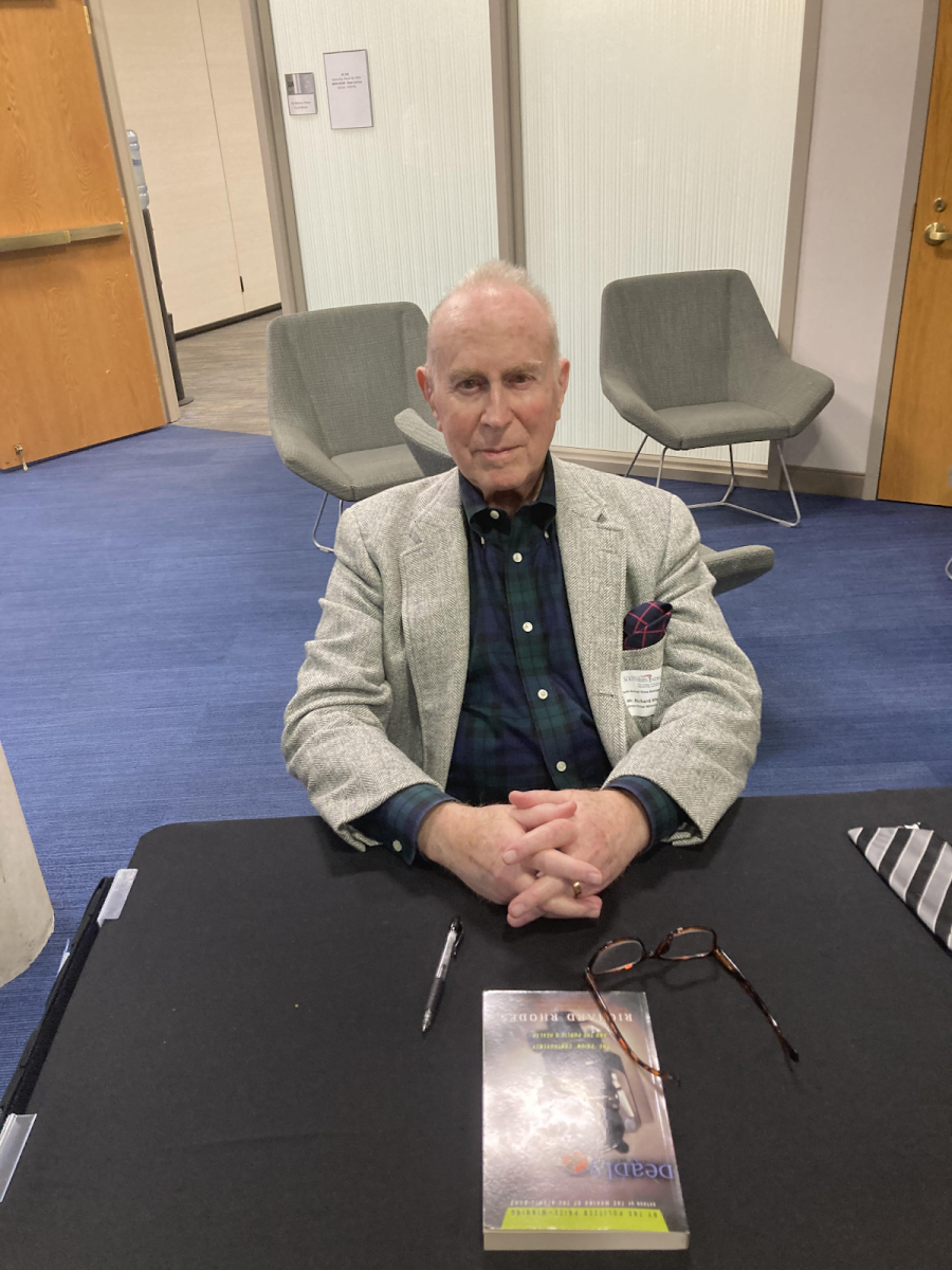 Richard Rhodes stays to sign books after the lecture. The most popular of the books was The Making of the Atomic Bomb. (Photo by Rose Robinson)