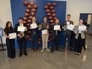 Seven USI students smile with their awards, ranging from first to third place, Saturday at the Indiana Association of School Broadcasters College Competition.