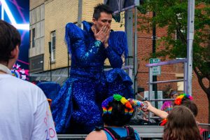 J.C. accepts a gift from the audience at the River City Pride Festival June 7 on Main Street, Evansville.