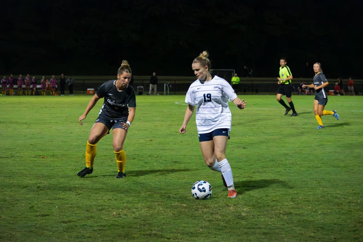 Emerson Grafton, senior forward, dribbles the ball on the left wing against a Valparaiso University defender Thursday at Strassweg Field. (Photo by Will Kessinger)