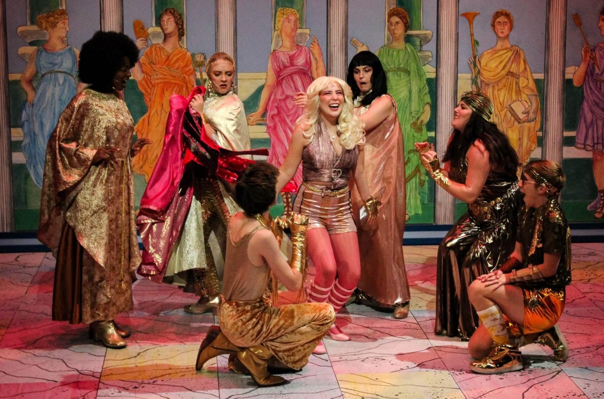 The Muses help Clio (LillyBea Ireland) change her outfit as she prepares to travel to Venice during “Xanadu” at the USI Performance Center Wednesday, Nov. 19.